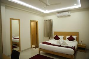 a hotel room with a bed and a mirror at IRIS HOTEL BY HOP in Tirupati