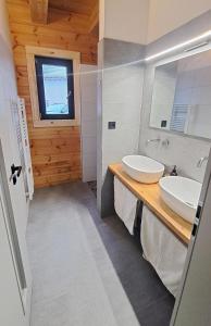 a bathroom with two sinks and a mirror at wellness roubenka Holčí in Miřetice