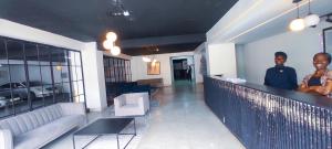 two people standing at a bar in a room at Dukes Suites in Nairobi +35 photos