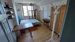 1 dormitorio con cama, escritorio y mesa en Appartement en maison de ville, en Pontarlier