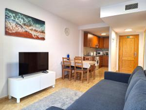 a living room with a couch and a flat screen tv at Casa Lilla - Ideal for couples in Los Alcázares
