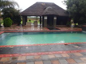 a swimming pool with a gazebo at Loding Lodge in Loding