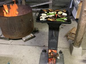 a grill with a pan of food and flames at あんばええ 