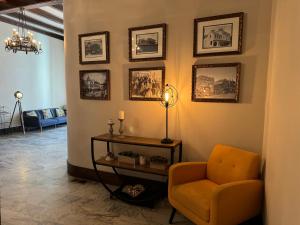 a living room with a chair and pictures on the wall at Historic Sonora Inn in Sonora