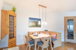 jadalnia z drewnianym stołem i krzesłami w obiekcie Rettenberger Murmele w mieście Rettenberg