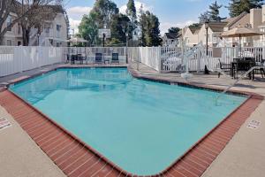 a large swimming pool with a white fence at Residence Inn Fremont Silicon Valley in Fremont