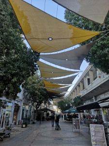 a large yellow and white umbrella over a city street at Unique City Centre Apartments in Nicosia