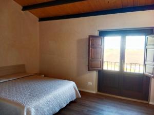 Postel nebo postele na pokoji v ubytování Vigna di pettineo - guest house