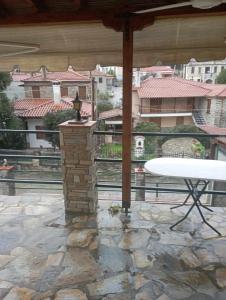 a patio with a table and a view of a building at Villa seniorita Annita in Nikiti