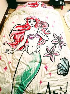 a blanket with a drawing of a mermaid on it at メゾンクレスタ in Tokyo