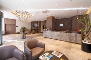 a lobby with chairs and a reception desk at Elite World Comfy Samsun Atakum in Atakum