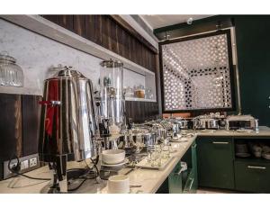 a kitchen counter with a bunch of appliances on it at Hotel Silk Inn, Gosaba, West Bengal in Ingrāj Bāzār