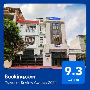 a rendering of a building with the words travel review awards at FabExpress JMD Inn in Lucknow