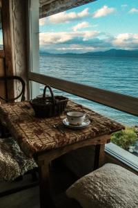 a table in a room with a view of the ocean at La Generosa in San Carlos de Bariloche