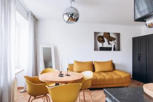 a living room with a table and a couch at Seaside Apartment in Liepāja