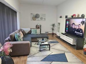 a living room with a couch and a flat screen tv at Wohnung 51 in Oberwesel