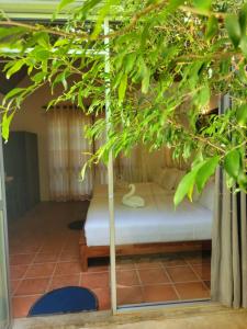a bedroom with a bed under a tree at Hantara Udawalawa in Udawalawe