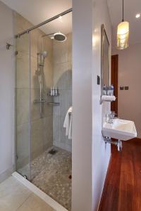 a bathroom with a shower and a sink at Deerpark Luxury Stays in Nairobi