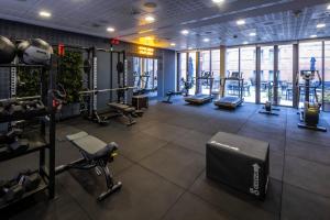 a gym with treadmills and machines in a room at Comfort Hotel Vesterbro in Copenhagen