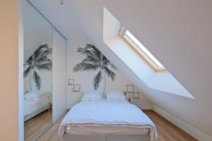 En eller flere senge i et værelse på La Brise Tropicale - Belle maison avec jardin