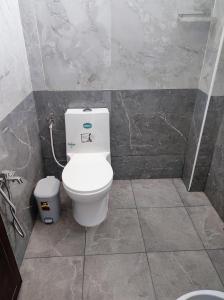 a bathroom with a toilet and a sink at Sri Aksha Residency in Alāndurai