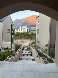 an archway with stairs in a city with buildings at Mountain View 1-Bedroom Villa in Franschhoek in Franschhoek