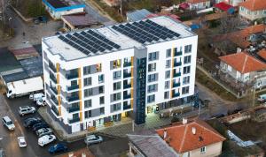 an overhead view of a white building with solar panels on it at Apartmenthaus Oborishte in Panagyurishte