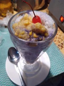 a glass bowl of food with a cherry on top at Bucana Kamp Payapa Beachfront in El Nido
