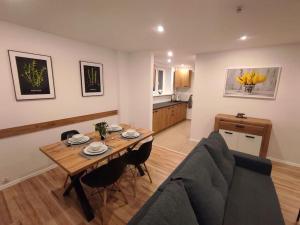 a living room with a table and a couch at Alicante Apartament - 48m² ✓ in Rybnik