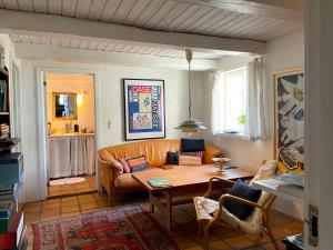 a living room with a couch and a table at pallisgaard B&B in Struer