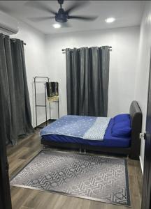 a bedroom with a bed in a room with curtains at Dya@Nas Homestay Arau in Arau
