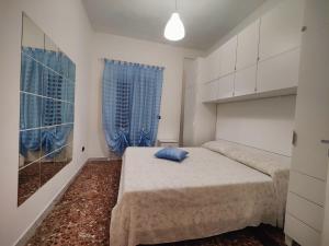 een slaapkamer met een bed met een blauw kussen erop bij Villa Lilly in Pulsano