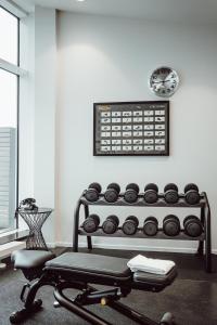 a room with a bench and a table and a clock at AMERON Hamburg Hotel Speicherstadt in Hamburg