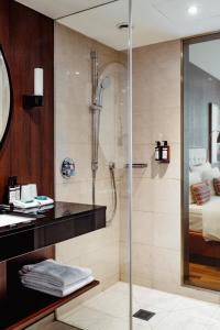a bathroom with a shower and a sink at AMERON Hamburg Hotel Speicherstadt in Hamburg