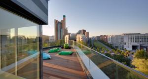 a balcony with a view of a city at Grimm's Potsdamer Platz in Berlin
