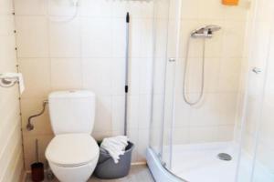 a bathroom with a toilet and a shower at Two storey holiday houses for 4 people Jaros awiec in Jarosławiec