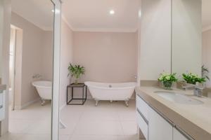 a bathroom with two sinks and a tub and two toilets at Sta Barbara Residence Hotel in Cebu City +37 photos