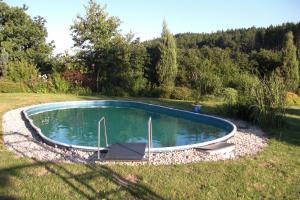 a small pool in the middle of a yard at Pension Lažany in Lažany