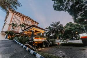 a building with a staircase in front of it at Arion Suites Hotel in Bandung