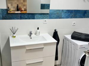 Un baño con un lavabo blanco y un espejo. en Mirador de Jandia, Wi Fi, AC, en Morro del Jable