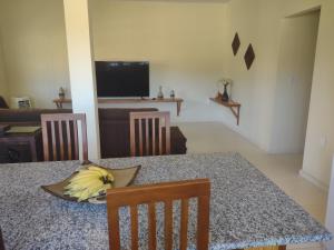 a dining room with a table with a bunch of bananas on it at Casa de praia em Canavieiras in Canavieiras