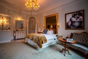 a bedroom with a bed and a table and a couch at Hotel Pigalle in Gothenburg