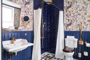 a bathroom with blue walls and a sink and a toilet at MJ's in Malmö