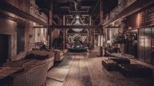 a living room with couches and tables in a building at Steam Hotel in Västerås