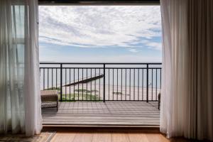 a balcony with a view of the ocean through a window at Ystad Saltsjöbad in Ystad