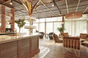Il comprend une cuisine et un salon avec un bar et des chaises. dans l'établissement Ellery Beach House, à Lidingö