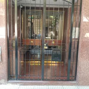 a glass door of a building with a fence at Depto La Boca in Buenos Aires