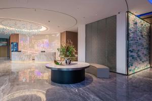 a lobby with a round table in a building at Holiday Inn Express Chongqing Nanbin Road, an IHG Hotel in Chongqing