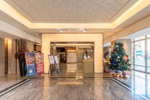 a christmas tree in the lobby of a hotel at CHECK inn SELECT Taichung Dadun in Taichung