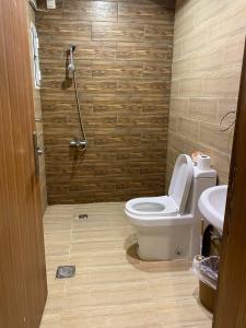 a bathroom with a shower and a toilet and a sink at Elegant apartment in Jeddah